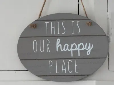 a sign that reads this is our happy place at Beach Side Bungalow in Lytham St Annes