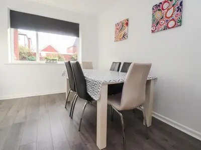 a dining room with a table and chairs at Beach Side Bungalow in Lytham St Annes