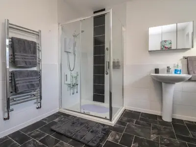 a bathroom with a shower and a sink at Beach Side Bungalow in Lytham St Annes