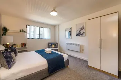 a bedroom with a large bed and a closet at Central 2 Bed Apt with Balcony in Liverpool