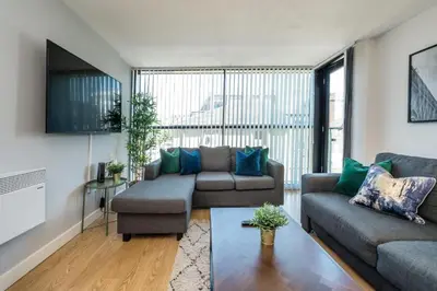 a living room with two couches and a table at Central 2 Bed Apt with Balcony in Liverpool