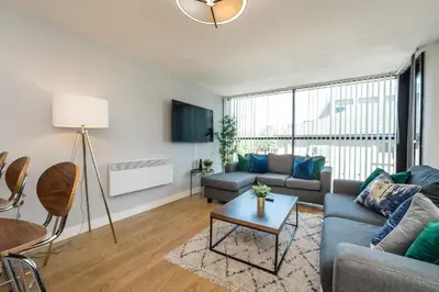 a living room with a couch and a table at Central 2 Bed Apt with Balcony in Liverpool