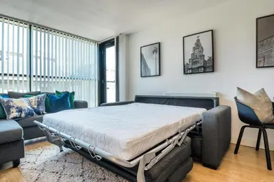 a bedroom with a bed and a couch at Central 2 Bed Apt with Balcony in Liverpool
