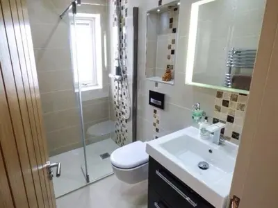 a bathroom with a shower and a toilet and a sink at Shreyas Cottage in Blackburn