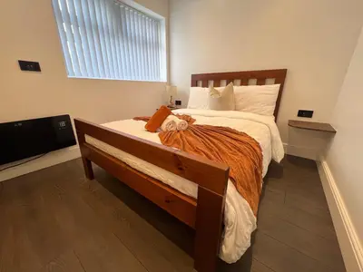 a bedroom with a bed and a large window at Liverpool Willow House - 4 Bed Close to Anfield Stadium in Liverpool