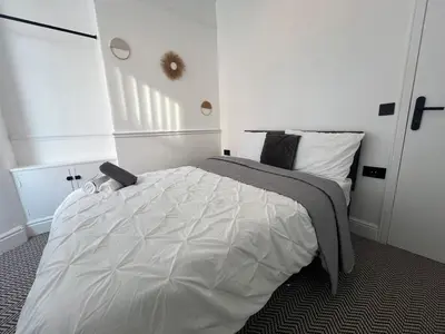 a bedroom with a large white bed in it at Liverpool Willow House - 4 Bed Close to Anfield Stadium in Liverpool