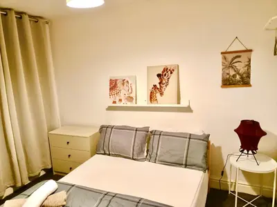 a small bedroom with a bed and a table at Cosy 4 Bedroom Liverpool Contractor & Family Stay in Liverpool