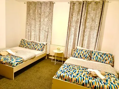 a bedroom with two beds and a window at Cosy 4 Bedroom Liverpool Contractor & Family Stay in Liverpool