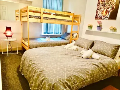 a bedroom with two beds and a bunk bed at Cosy 4 Bedroom Liverpool Contractor & Family Stay in Liverpool