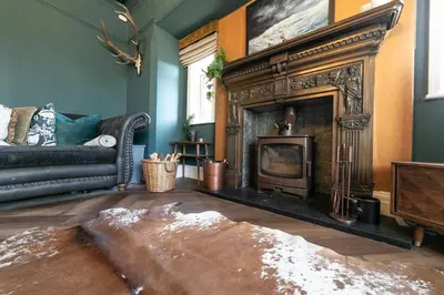 a living room with a fireplace and a couch at Crookdale House By Holiday Heim Country Manor With Private Pool And Bar in Preesall