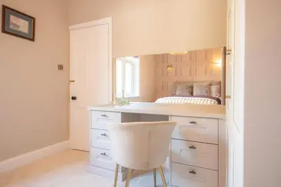 a bedroom with a desk with a bed in it at Crookdale House By Holiday Heim Country Manor With Private Pool And Bar in Preesall