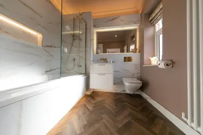 a bathroom with a toilet and a glass shower at Crookdale House By Holiday Heim Country Manor With Private Pool And Bar in Preesall