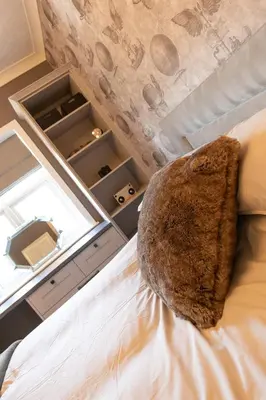 a room with a bed with a window and a chair at Crookdale House By Holiday Heim Country Manor With Private Pool And Bar in Preesall