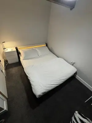 a small bedroom with a white bed in a room at Spacious Modern flat Blackburn in Blackburn