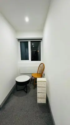 a room with a chair and a table and a window at Preston City centre Winckley Square Flat in Preston