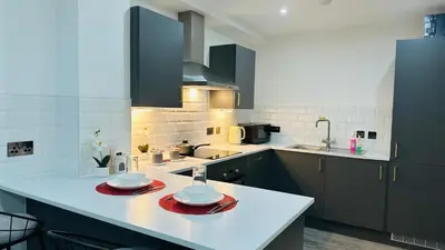 a kitchen with a counter with two plates on it at Preston City centre Winckley Square Flat in Preston