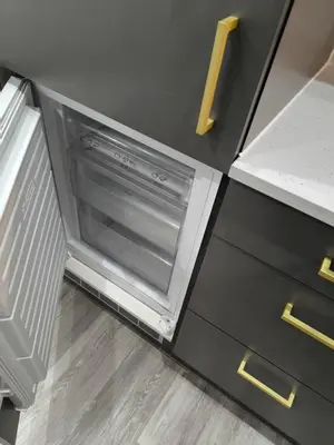 a small kitchen with an open oven in a cabinet at Preston City centre Winckley Square Flat in Preston