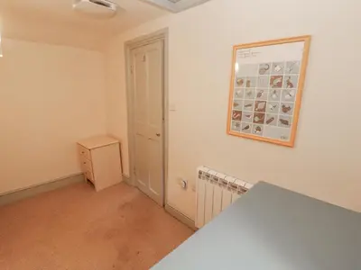 an empty room with a picture on the wall at Rock Cottage in Milnthorpe