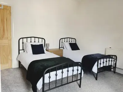 two beds sitting next to each other in a bedroom at Wordsworth House by Sapphire Properties -Near to BAE Systems in Barrow in Furness