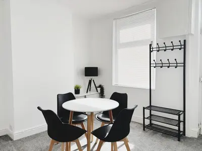 a dining room with a white table and chairs at Wordsworth House by Sapphire Properties -Near to BAE Systems in Barrow in Furness