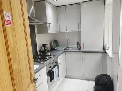 a kitchen with white cabinets and a stove top oven at Wordsworth House by Sapphire Properties -Near to BAE Systems in Barrow in Furness