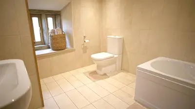 a bathroom with a toilet and a sink at Tunstall Ing Farmhouse - Duchy of Lancaster Estate in Whitewell