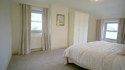 a bedroom with a bed and a window at Tunstall Ing Farmhouse - Duchy of Lancaster Estate in Whitewell