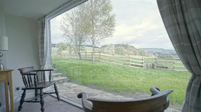 a room with a window with a view of a field at Tunstall Ing Farmhouse - Duchy of Lancaster Estate in Whitewell
