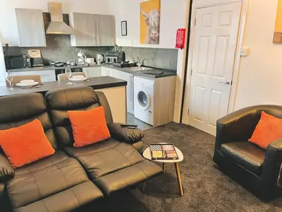 a living room with a couch and chairs in a kitchen at Ideal pay-as-you-stay 1-bed apartment in Preston in Preston