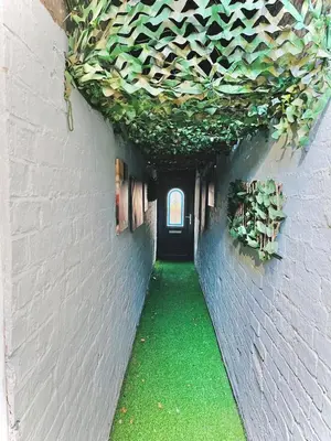 a hallway with a tunnel with plants on the walls at Ideal pay-as-you-stay 1-bed apartment in Preston in Preston