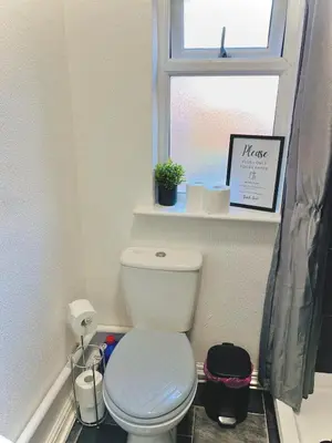a bathroom with a white toilet and a window at Ideal pay-as-you-stay 1-bed apartment in Preston in Preston