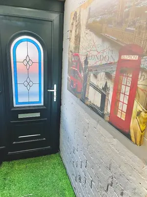 a black door with a painting of a red telephone booth at Ideal pay-as-you-stay 1-bed apartment in Preston in Preston