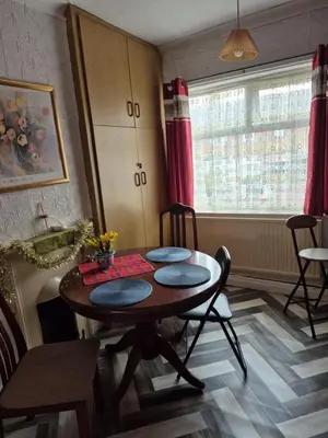 a room with a table and chairs and a window at Confort Flat in Preston