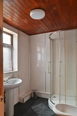 a bathroom with a shower and a toilet and a sink at Confort Flat in Preston