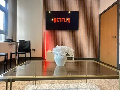 a vase of flowers sitting on a glass table at 65 Inch TV City Center 1BR Long Stay Ready in Liverpool