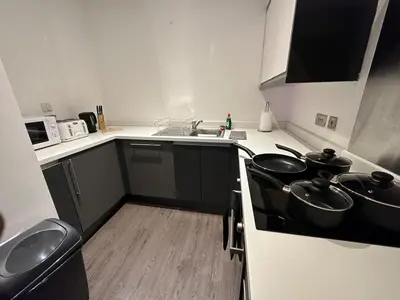a kitchen with a sink and a stove top oven at 65 Inch TV City Center 1BR Long Stay Ready in Liverpool