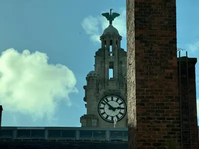 a clock tower with a statue on top of it at 65 Inch TV City Center 1BR Long Stay Ready in Liverpool