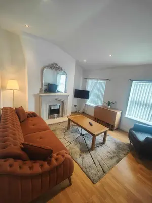 a living room with a couch and a table at Home from home - 2 bedroom apartment in Liverpool