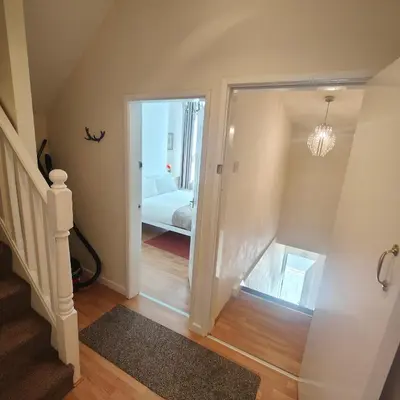 a hallway with a door leading to a bedroom at Home from home - 2 bedroom apartment in Liverpool