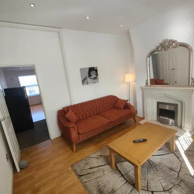 a living room with a couch and a table at Home from home - 2 bedroom apartment in Liverpool