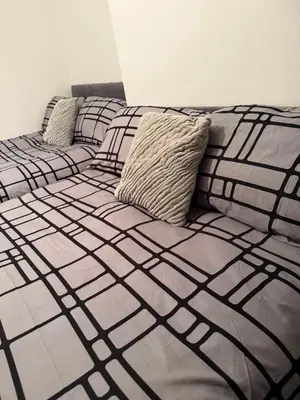 a bed with two pillows on it in a room at City Apartment in Litherland