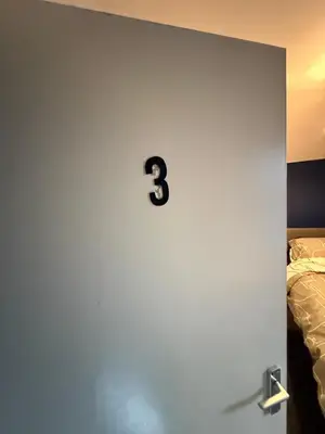 a door with a number three on it next to a bed at Home From Home in Liverpool