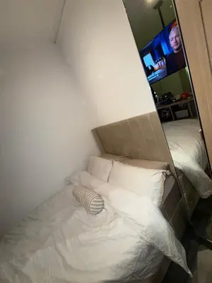 a white bed in a room with a mirror at Home From Home in Liverpool