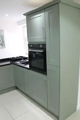 a kitchen with gray cabinets and a microwave at Whole home Aintree Racecourse in Fazakerley