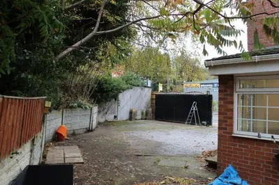a backyard of a house with a fence at Whole home Aintree Racecourse in Fazakerley