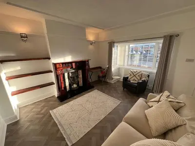 a living room with a couch and a chair at Whole home Aintree Racecourse in Fazakerley