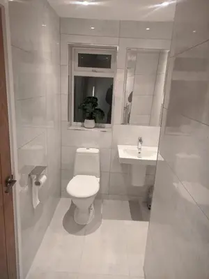 a white bathroom with a toilet and a sink at Dream101, Luxury 2 Bedroom apartment - free parking in Liverpool