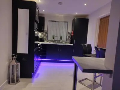 a kitchen with a purple light in the middle at Dream101, Luxury 2 Bedroom apartment - free parking in Liverpool
