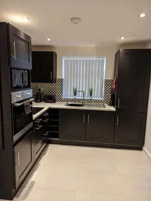 a kitchen with black appliances and a window in it at Dream101, Luxury 2 Bedroom apartment - free parking in Liverpool