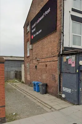 a brick building with a sign on the side of it at Dream101, Luxury 2 Bedroom apartment - free parking in Liverpool